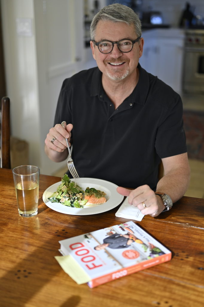 Mark Burhenne smiling eating food